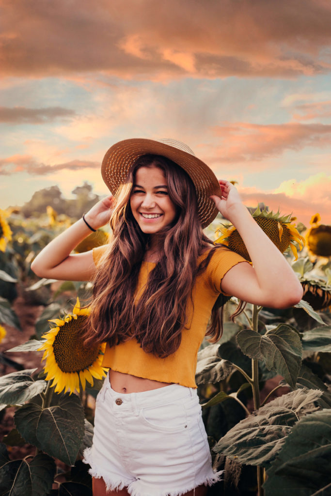 London Family Photographer, girl wearing a hat in a sunflower field